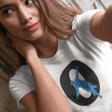 Load image into Gallery viewer, girl in a white t-shirt large logo with a large letter O in black  and a blue  dance silhouette place inside with one foot outside the letter O
