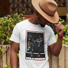 Load image into Gallery viewer, man-with-a-fedora-hat-wears-a-white-t-shirt-with-a-front-print-with-a-couple-dancing-and-underneath-says-mambo
