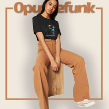 Load image into Gallery viewer, girl-sitting-wearing-a-black-t-shirt-with-a-face-and-text-on-the-front

